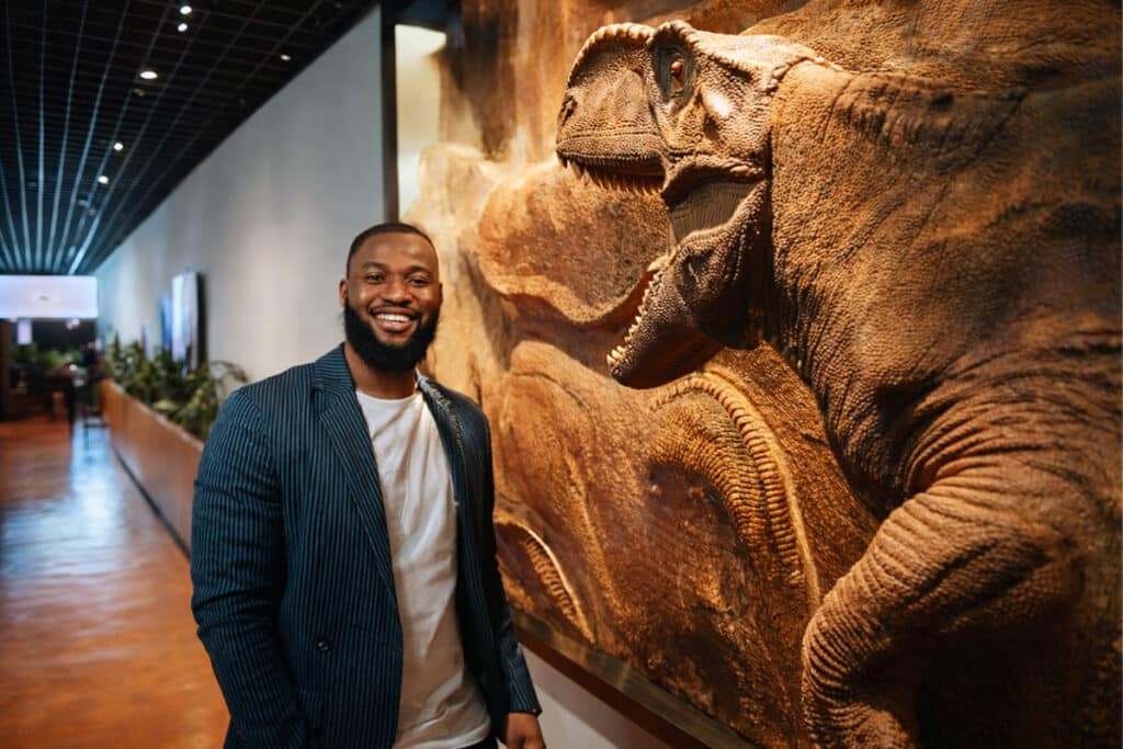 Man and dinosaur in museum hallway